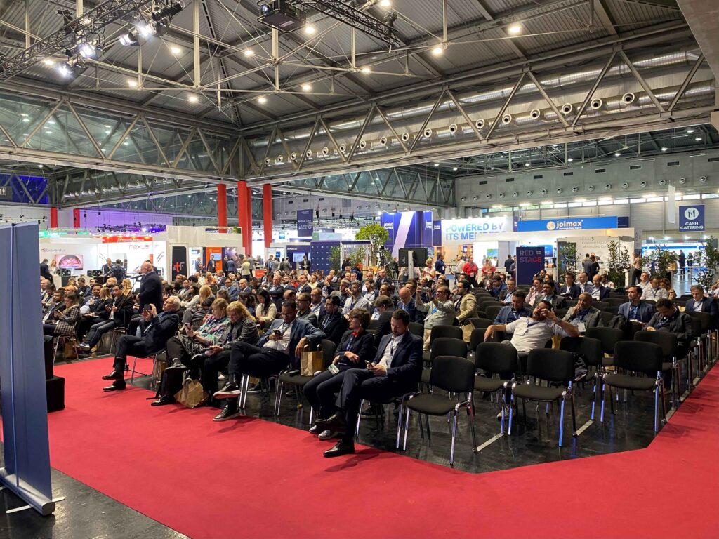Attendees at an expert talk by an Espinea faculty at the Joimax booth at Eurospine 2024 in Vienna.