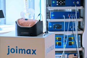 upsurgeOn lumbar spine model customized for joimax on a white table and a NAVENTO Tower in the background